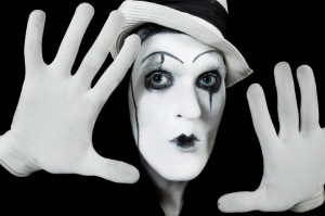 face and hands of mime with dark make-up