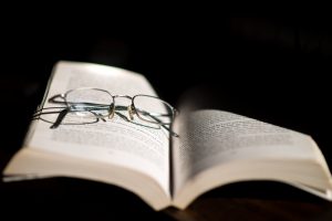 Reading Glasses Resting On Open Book